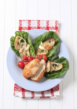 Pan roasted chicken breast with crispy bread and lettuce