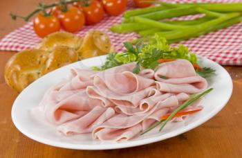 Thin slices of ham on plate