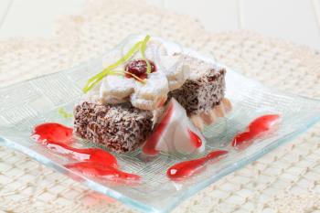 Chocolate dipped mini cakes coated in desiccated coconut and jam biscuit