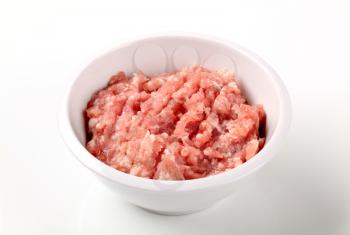 Raw minced beef in a white bowl