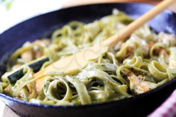 Spinach fettuccine with chicken, basil pesto and cream sauce 