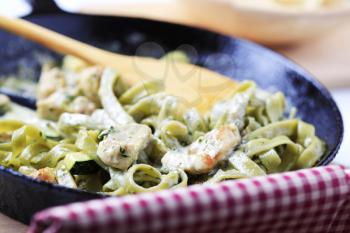 Spinach fettuccine with chicken, basil pesto and cream sauce 