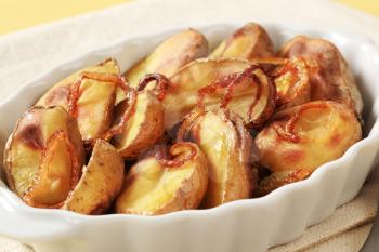 Roasted potatoes and browned onion in a casserole dish