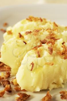 Detail of mashed potato topped with browned onion
