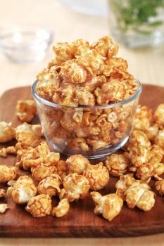 Glass bowl of popcorn coated with caramel