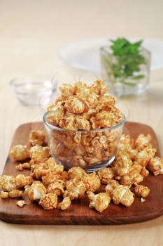 Glass bowl of popcorn coated with caramel