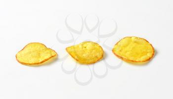Three potato chips on white background
