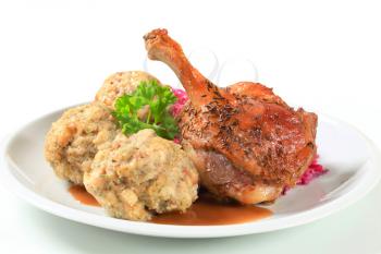 Dish of roast duck leg with Tyrolean dumplings and red cabbage