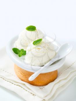Scoops of white creamy ice cream in a dessert bowl