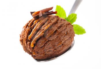 Scoop of chocolate fudge ice cream on spoon