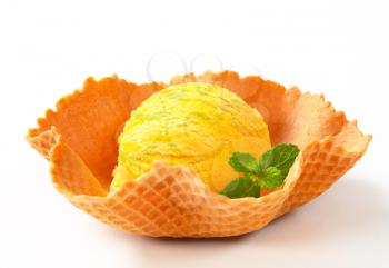 Scoop of yellow ice cream in a wafer bowl