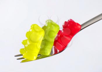 Three gummy bears on a fork