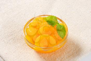 Bowl of peeled mandarin orange segments in light syrup
