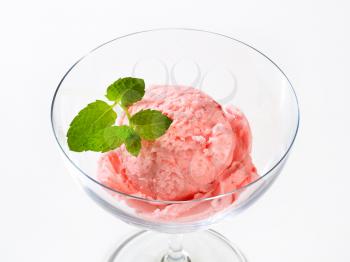 Scoop of strawberry ice cream in a coupe