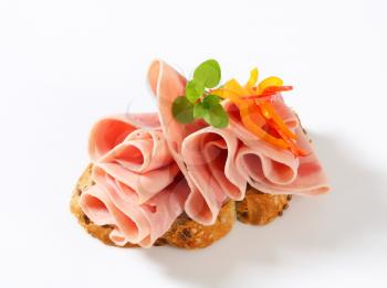 Thin slices of ham on wholegrain bread