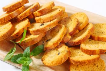 Small round toasts with black olives