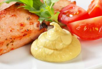 Pan-fried slices of meatloaf with mustard