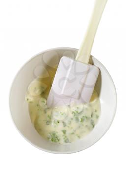 Homemade dressing in ceramic bowl with spatula