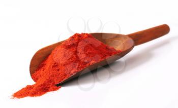 Heap of paprika powder on a wooden scoop
