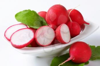 Fresh red radishes in a bowl