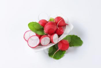 Fresh red radishes on white background