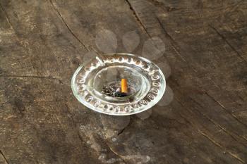 dirty ashtray on wooden table