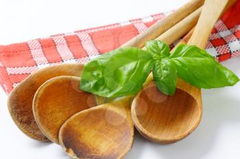 group of wooden spoons on red dish towel