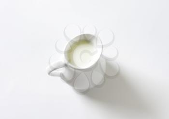 Fresh milk in white pitcher