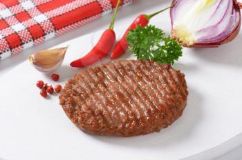 Grilled Beef Burger Patty on cutting board