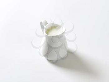 Fresh milk in white pitcher