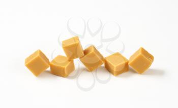 Chewy toffee candies on white background