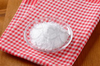 Coarse grained edible salt on small glass plate