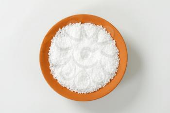 Coarse grained salt in terracotta bowl