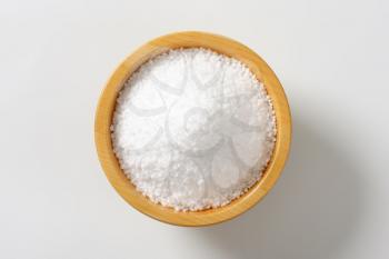 Coarse grained salt in wooden bowl