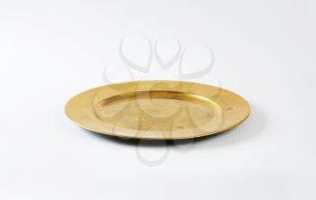 Round gold charger plate with wide rim