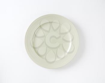 Bone white dinner plate with embossed rings on the rim