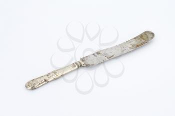 rusty old table knife on white background