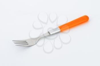 dinner fork with orange plastic handle