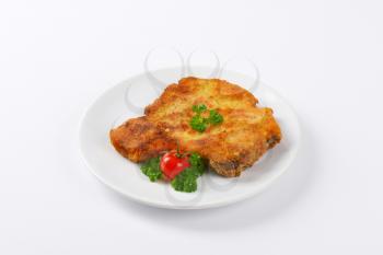 fried breaded pork chop on white plate