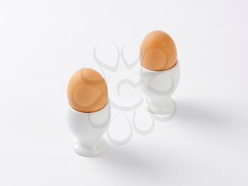 two soft boiled eggs in white eggcups