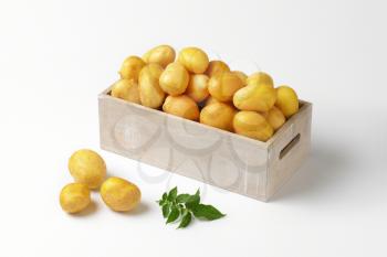 box of raw unpeeled potatoes