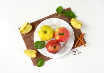 plate of apples and apple wedges on bamboo place mat