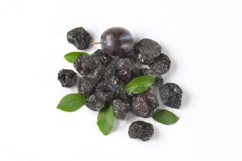 group of dried plums on white background