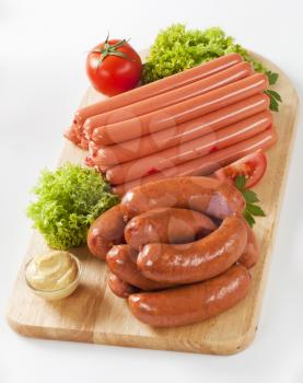 variety of sausages on wooden cutting board
