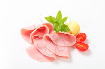 Thin slices of ham on white background