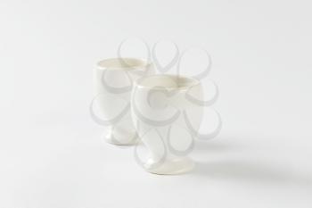 Two empty white porcelain egg cups