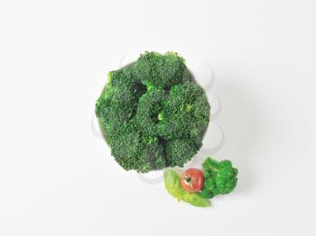 Raw broccoli florets in white bowl 