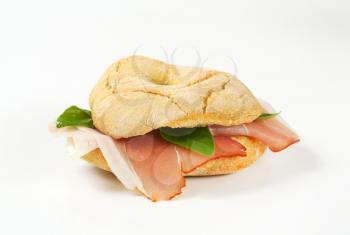 Ring-shaped bread roll (friselle) with slices of Schwarzwald ham