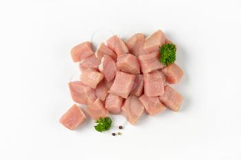 Diced lean raw pork on white background