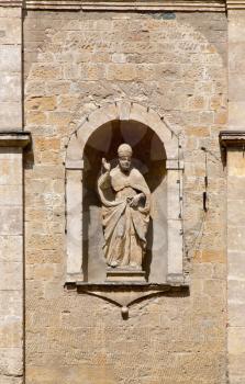 Statue on the front facade of the Church of San Pietro in Selci in Volterra, Tuscany, Italy